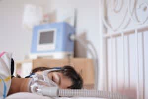 stock photo of a woman sleeping with a bipap machine