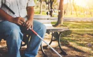 stock photo of a blind man sitting on a bench