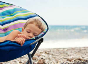 young boy napping in summertime