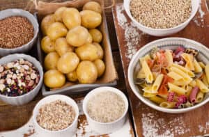 Bowls of carb-loaded food situated on a table