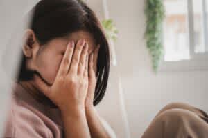 Woman sitting with her her face in her hands