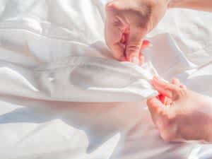 stock image of a person holding a duvet cover