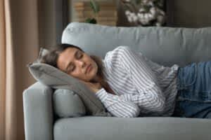 stock photo of a woman taking a nap on a couch