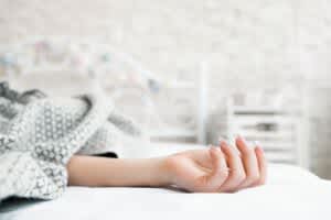 stock photo of a hand resting on a bed