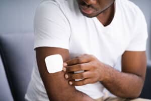 A man applies a melatonin patch