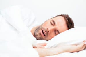 stock photo of a man sleeping with his mouth open