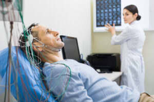 A medical professional prepares a patient for a sleep study