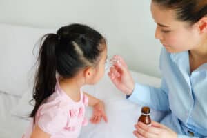 A little girl taking medicine