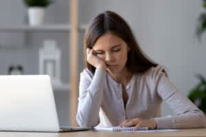 stock photo of a woman resting her face in her hand