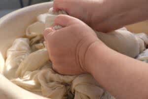 stock photo of a person washing sheets by hand