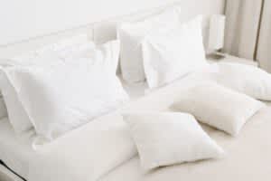 stock photo of different sized pillows on a mattress