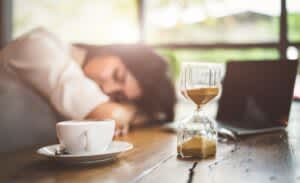 stock photo of a woman taking a power nap at her desk