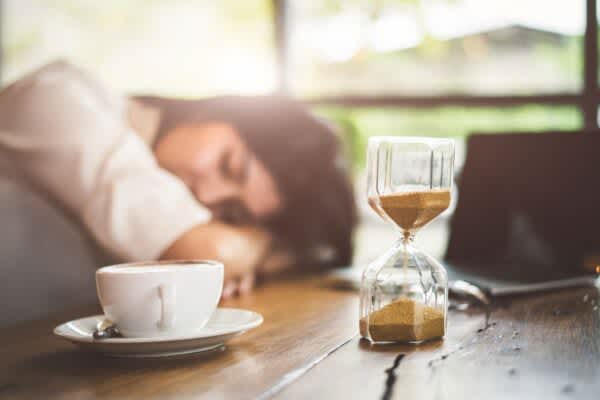 stock photo of a woman taking a power nap at her desk