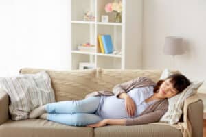 Pregnant woman resting on a couch