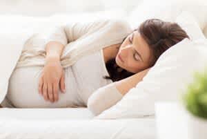 stock photo of a pregnant woman laying in bed