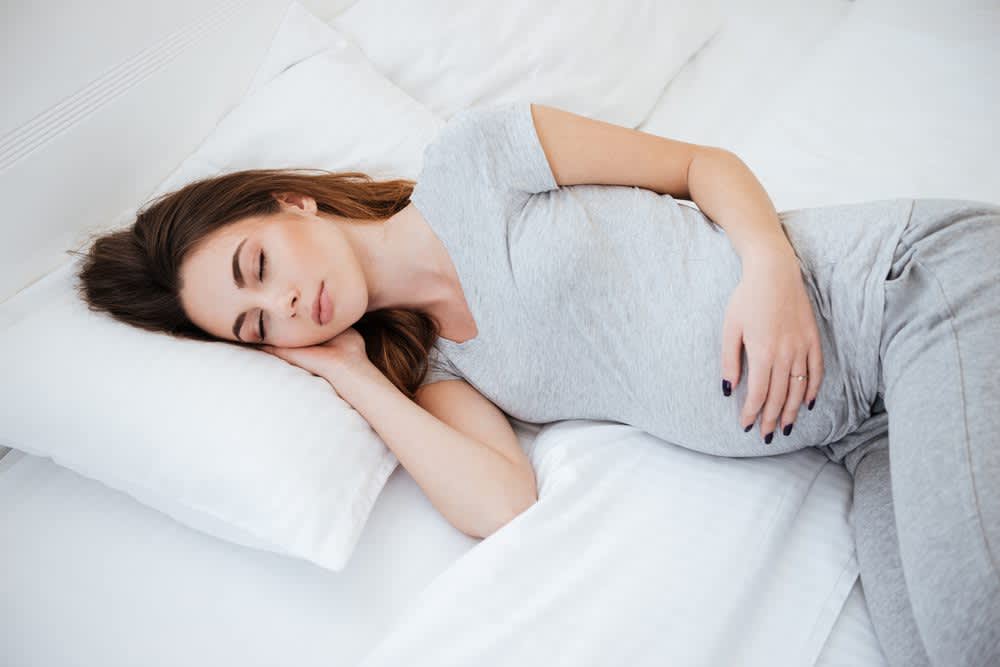 stock image of a pregnant woman sleeping