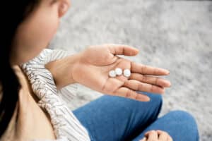 woman holding melatonin